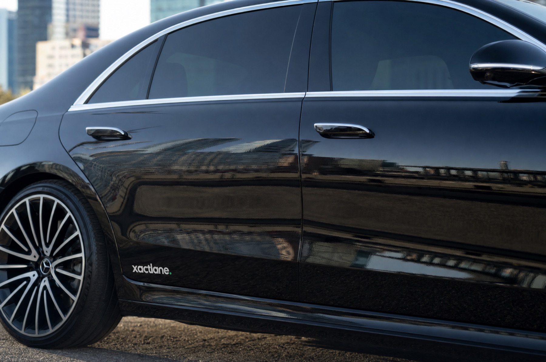 Xactlane vehicle branding — decal on a black limousine